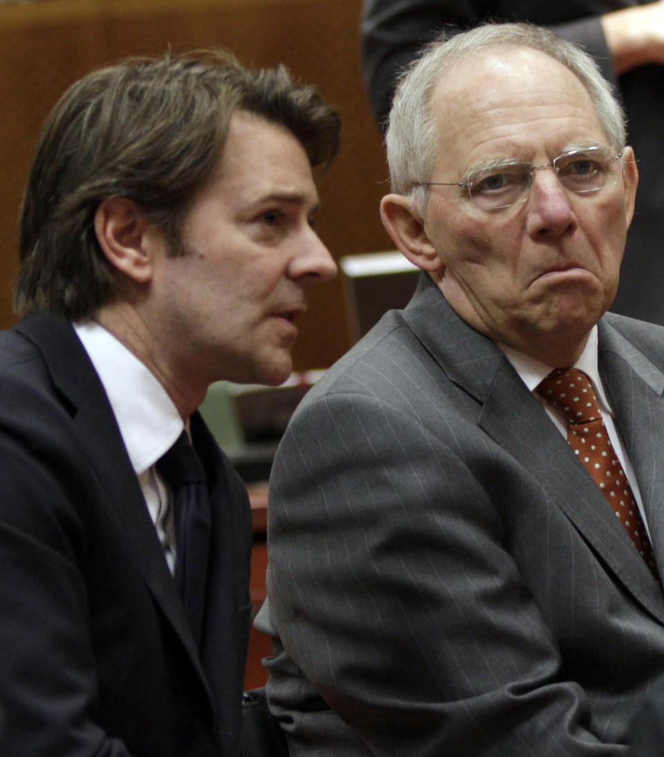 French Finance Minister Francois Baroin, left, speaks with German Finance Minister Wolfgang Schaeuble during a meeting of EU finance ministers at the EU Council building in Brussels on Tuesday, March 13, 2012. The decision to give Spain some more leeway on cutting this year's deficit is already triggering demands for more fiscal leniency for other European countries. Finance ministers from the eurozone said Monday that Spain will be allowed to run a deficit of 5.3 percent of gross domestic product this year, above the original 4.4 percent target. (AP Photo/Virginia Mayo)