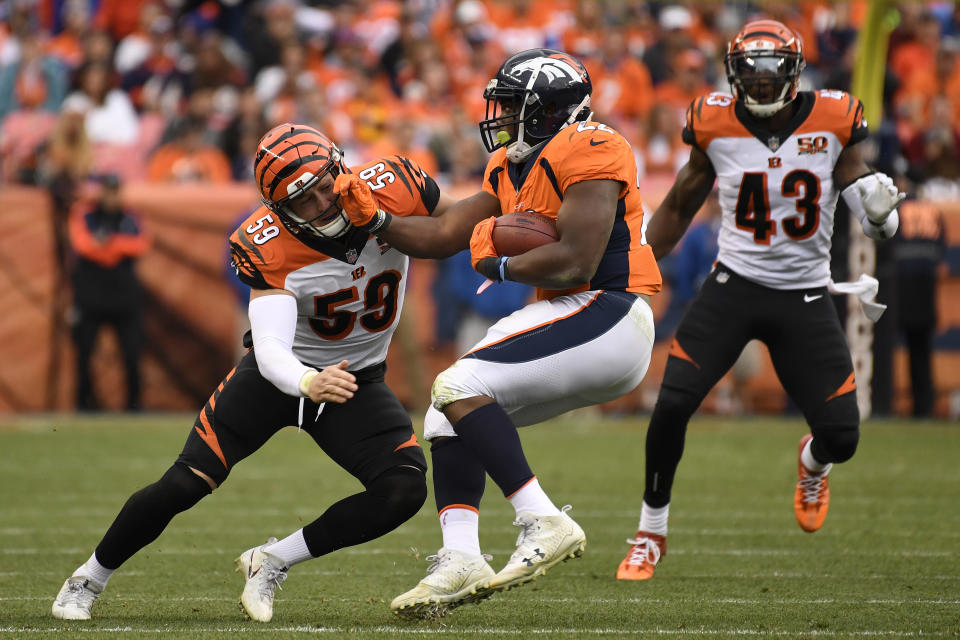 <p>C.J. Anderson (22) of the Denver Broncos pushes aside Nick Vigil (59) of the Cincinnati Bengals during the second quarter. The Denver Broncos hosted the Cincinnati Bengals at Sports Authority Field at Mile High in Denver, Colorado on Sunday, November 19, 2017. (Photo by Joe Amon/The Denver Post) </p>