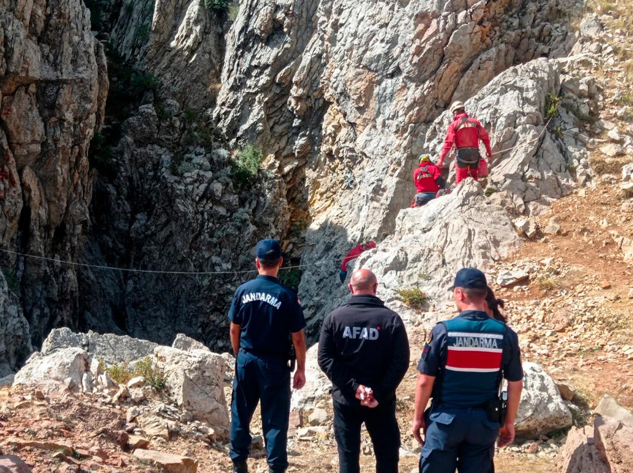 European Cave Rescue Association (ECRA) members and Turkish gendarmerie officers stand next to the entrance of Morca cave near Anamur, southern Turkey, Thursday, Sept. 7, 2023 (AP)