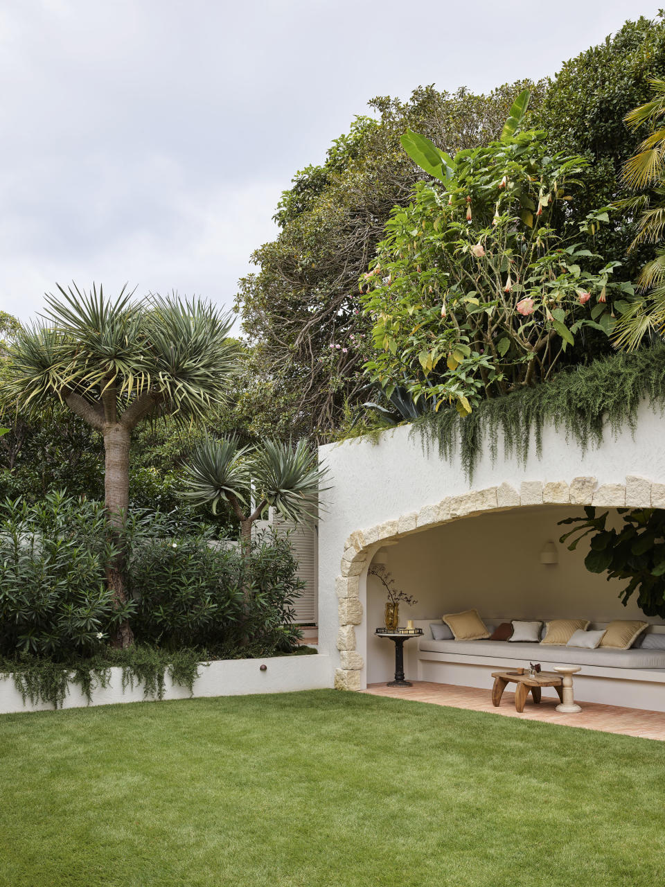 backyard with sheltered cave nook and palm trees by Wyer & Co