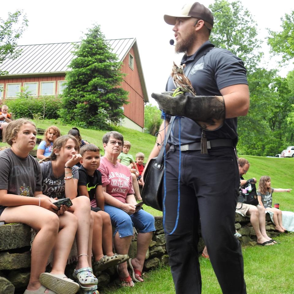 Adam McGuire with a screech owl, the smallest bird of prey, brought by Midwest Falconry to a recent presentation at Clary Gardens. Two shows were given with one primarily targeted at the botanical garden's youth summer program.