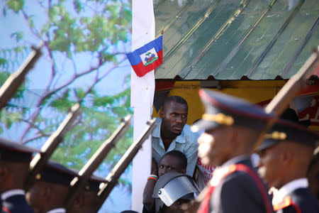 Residents watch as members of the Haitian Armed Forces (FAD'H) parade in the streets of Cap-Haitien, Haiti, November 18, 2017. REUTERS/Andres Martinez Casares