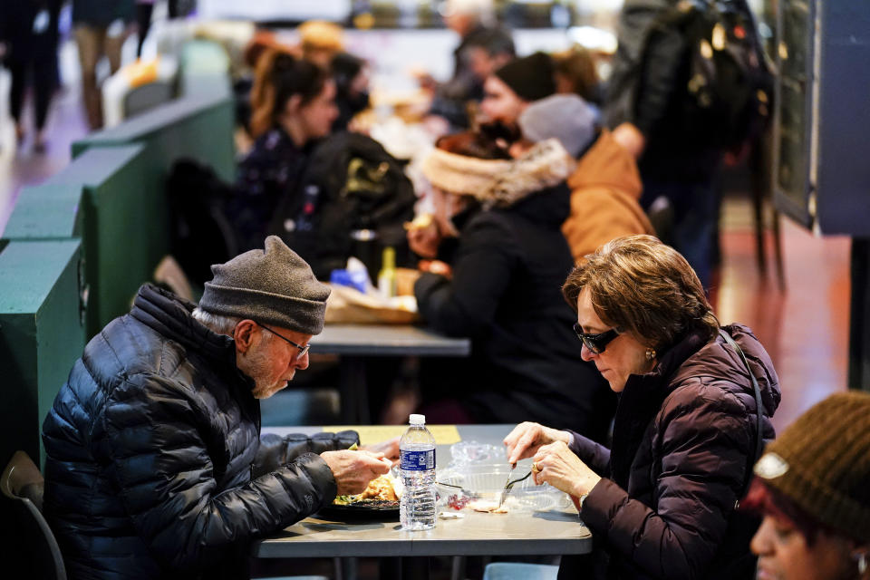 Customers eat at the Reading Terminal Market in Philadelphia, Wednesday, Feb. 16, 2022. (AP Photo/Matt Rourke)