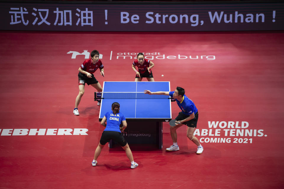 A slogan to support the Chinese city of Wuhan is displayed on an advertising board during the Table Tennis German Open mixed final between China's Liu Shiwen and Xu Xin and Japan's Mima Ito and Jun Mizutani in Magdeburg, Germany, Saturday, Feb. 1, 2020. (Swen Pfoertner/dpa via AP)