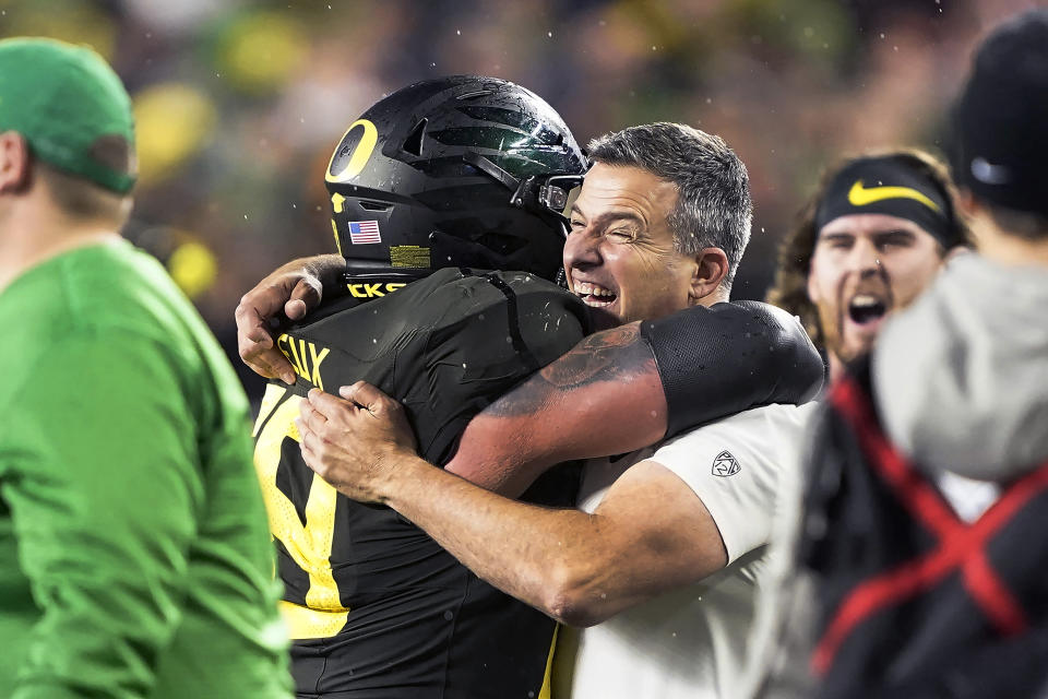 Oregon coach Mario Cristobal, right, celebrates with offensive lineman Shane Lemieux (68) after Oregon defeated Utah 37-15 in and NCAA college football game for the Pac-12 Conference championship in Santa Clara, Calif., Friday, Dec. 6, 2018. (AP Photo/Tony Avelar)