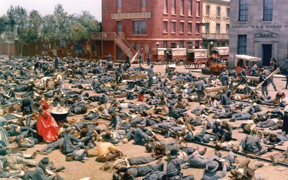 ‘A skeleton key that unlocks America’s illusions about itself’: Scarlett O’Hara (Vivien Leigh) tends to wounded soldiers in the 1939 film Gone with the Wind - Getty