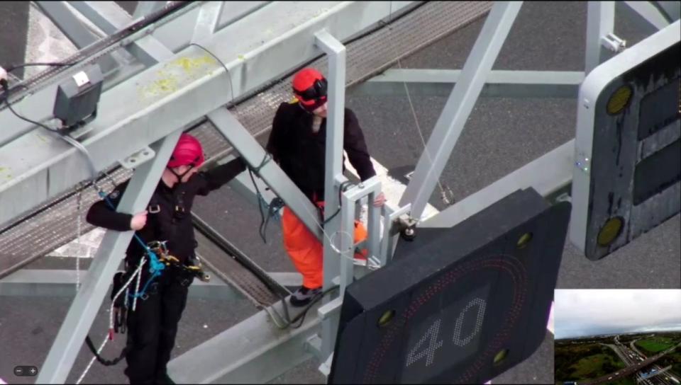 A specialist officer removes a protester from a gantry (Essex Police)