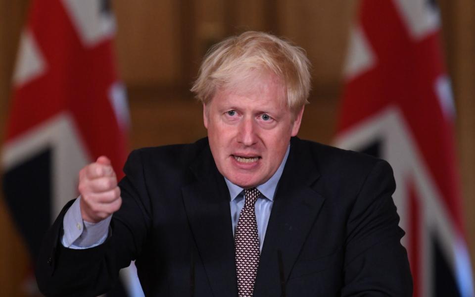 Prime Minister Boris Johnson speaks during a virtual press conference at Downing Street about lockdown restrictions in England - AFP