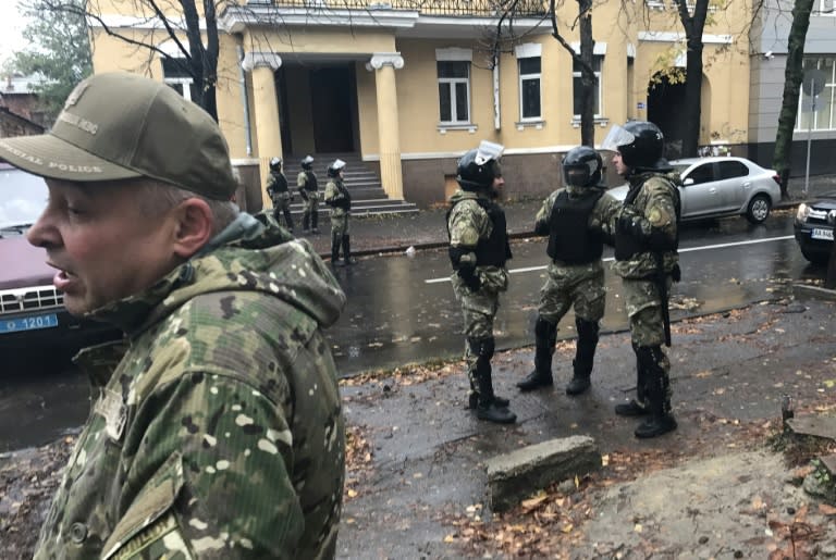 This picture taken with a mobile phone shows police securing the street of the flat of the interior minister's son Oleksandr Avakov, as Ukrainian anti-corruption investigators search the flat in Kharkiv on October 31, 2017