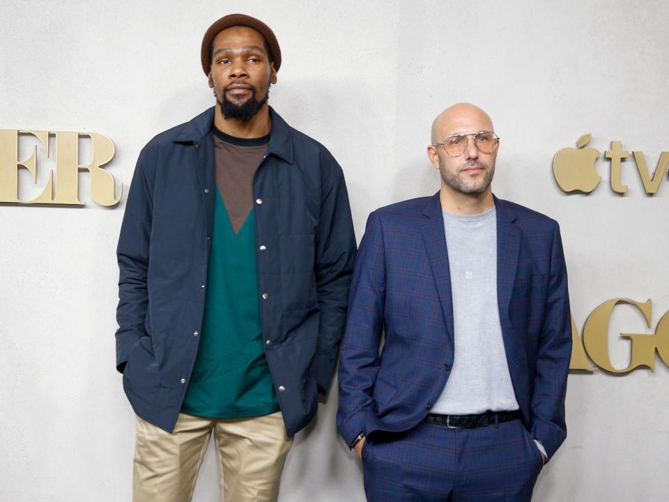 Kevin Durant and Rich Kleiman pose at an event.