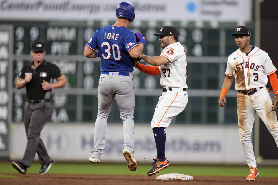 Houston Astros second baseman Jose Altuve (27) tags out Texas Rangers' Nathaniel Lowe (30) on a force to end the top of the fifth inning of a baseball game Tuesday, Sept. 6, 2022, in Houston. (AP Photo/Eric Christian Smith)