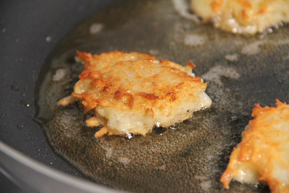 Latkes in a frying pan.