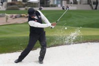 S.H. Kim, of South Korea, hits out of a greenside bunker on the second hole during the continuation of the second round of the Phoenix Open golf tournament Saturday, Feb. 10, 2024, in Scottsdale, Ariz. (AP Photo/Ross D. Franklin)