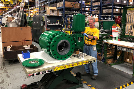 FILE PHOTO: A worker assembles an industrial valve at Emerson Electric Co.’s factory in Marshalltown, Iowa, U.S., July 26, 2018. REUTERS/Timothy Aeppel/File Photo