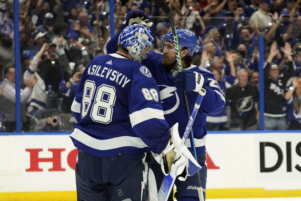 Tampa Bay Lightning goaltender Andrei Vasilevskiy (88) celebrates with defenseman Ryan McDonagh (27) after the Lightning eliminated the Florida Panthers during Game 4 of an NHL hockey second-round playoff series Monday, May 23, 2022, in Tampa, Fla. (AP Photo/Chris O'Meara)