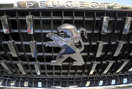 The logo of Peugeot carmaker is seen on a vehicle in Cairo