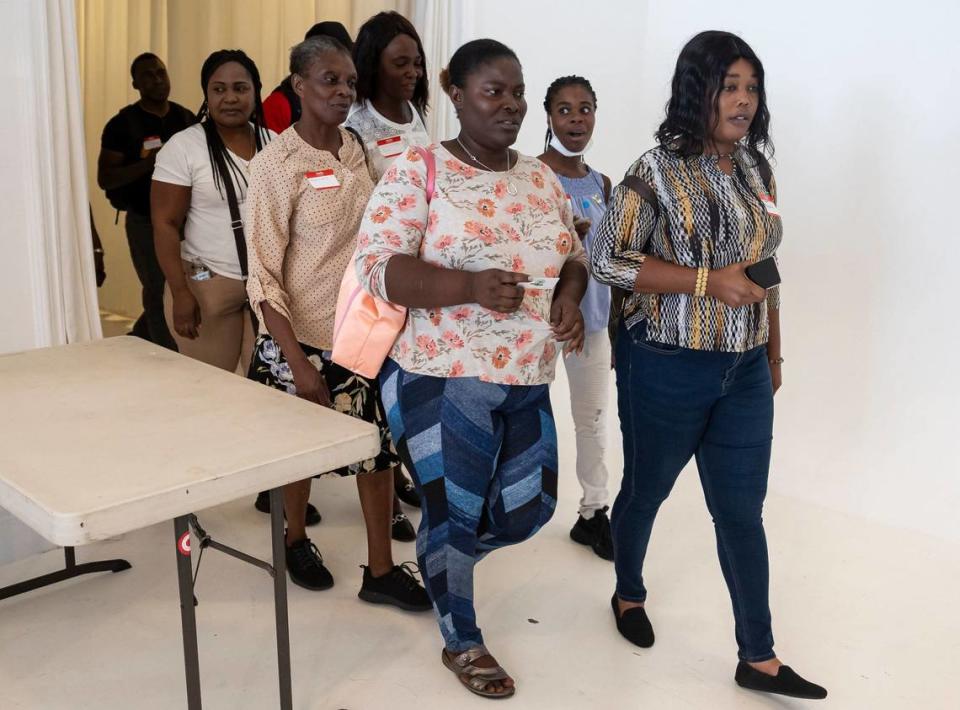 A group of attendees make attend a community resource fair at the Magic City Innovation District on Friday, May 31, 2024, in Miami, Fla. The fair aimed at helping recently arrived Haitians and other immigrants connect with health care providers and prospective employers.