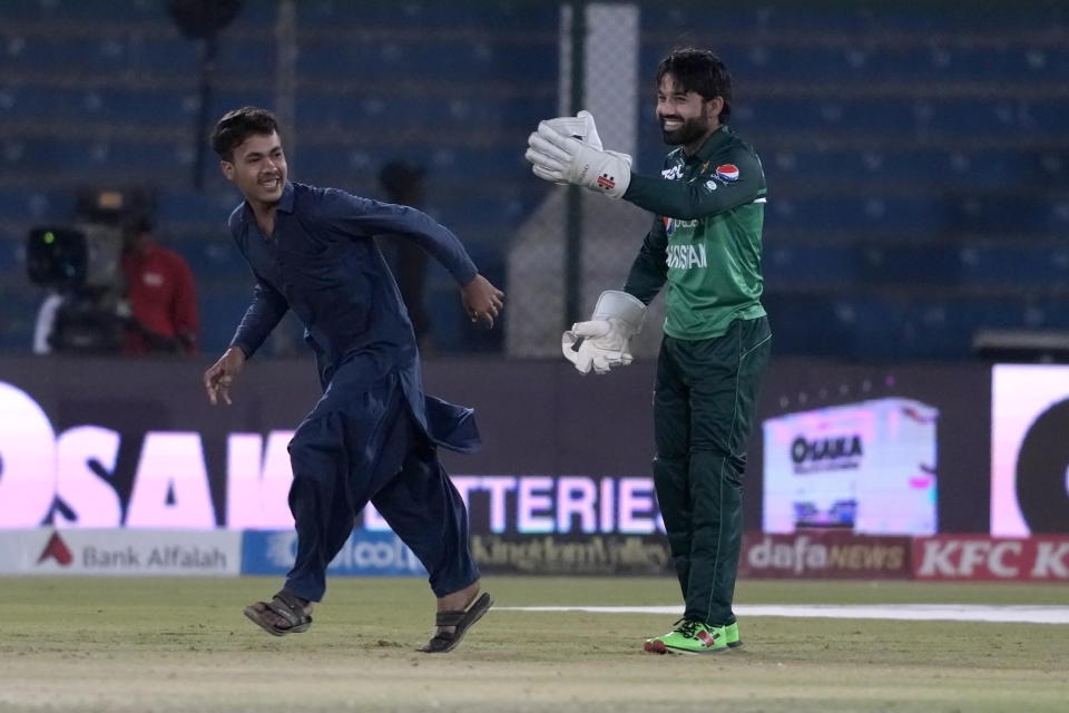 Pakistan's Mohammad Rizwan gestures toward a pitch invader during the second one-day international cricket match between Pakistan and New Zealand, in Karachi, Pakistan, Wednesday, Jan. 11, 2023. (AP Photo/Fareed Khan)