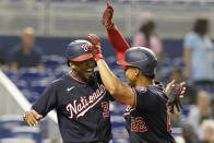 Washington Nationals' Alcides Escobar (3) cheers Juan Soto (22) after Soto hit a two-run home run during the third inning of a baseball game against the Miami Marlins, Wednesday, Sept. 22, 2021, in Miami. (AP Photo/Marta Lavandier)