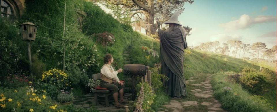 Gandalf and Bilbo Baggins sit at Bag End, Bilbo Baggins' home.