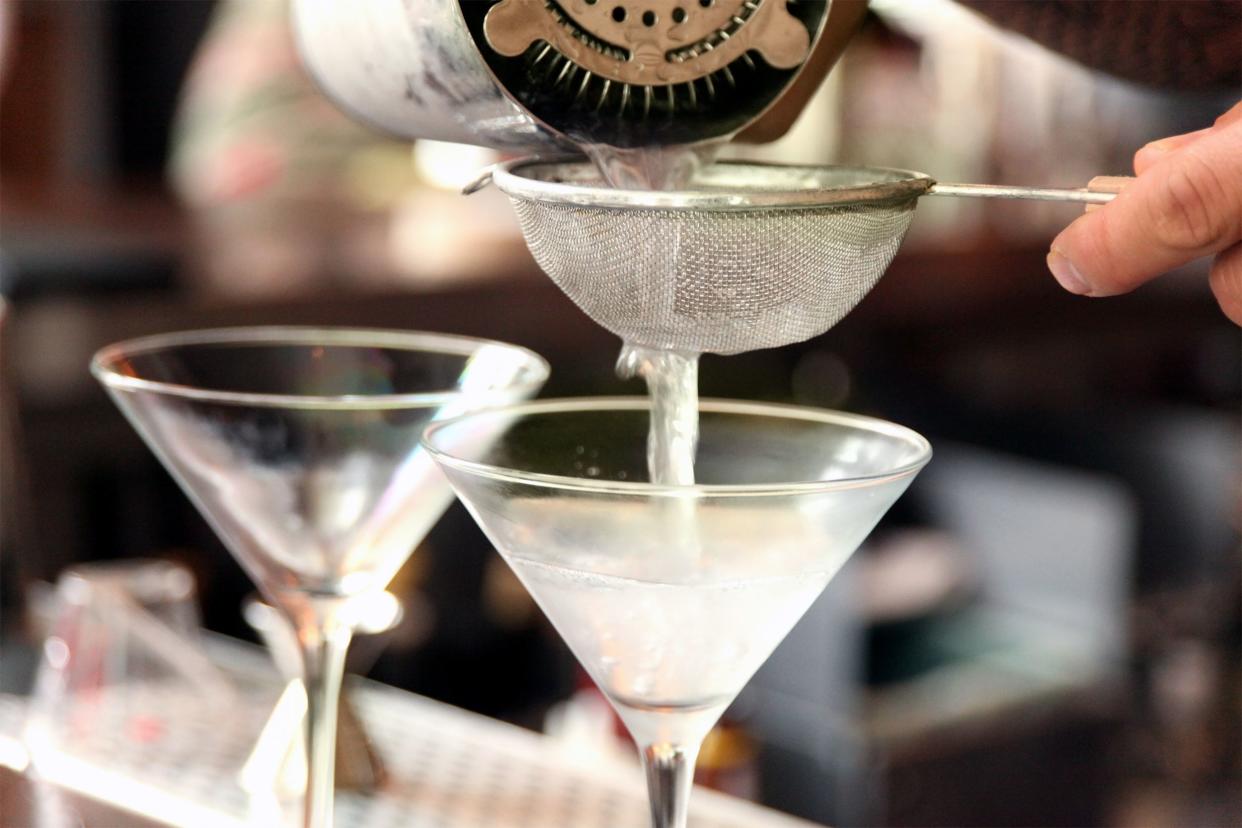 Closeup of bartender pouring martinis