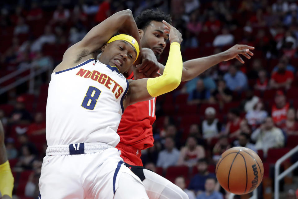 Denver Nuggets forward Peyton Watson (8) is fouled on a rebound by Houston Rockets forward Tari Eason, right, during the first half of an NBA basketball game, Tuesday, April 4, 2023, in Houston. (AP Photo/Michael Wyke)