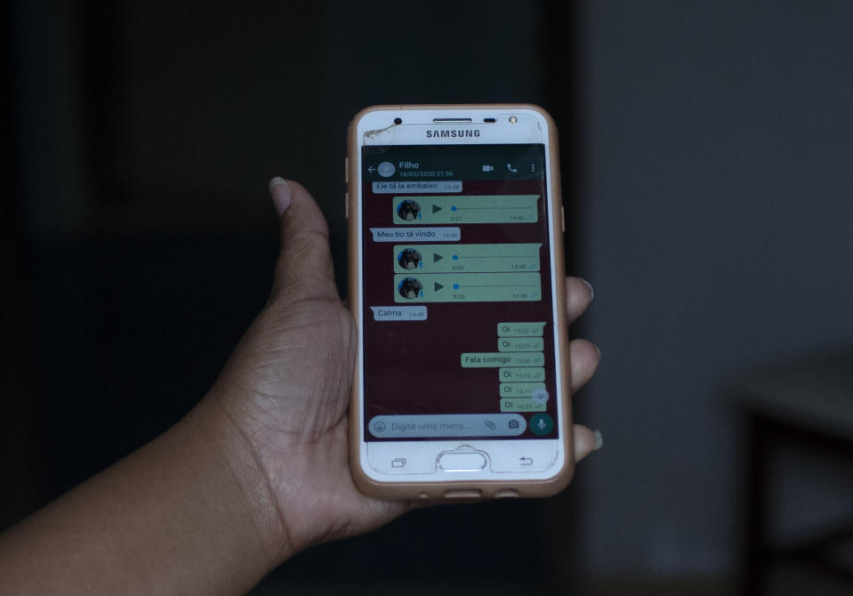 In this Monday, June 15, 2020 photo, Rafaela Matos shows the last text messages from her son João Pedro Matos Pinto, at her home in Sao Goncalo, Brazil. Rio de Janeiro police initially said they were pursuing a criminal in a joint operation by civil, military and federal police officers when they shot João Pedro on May 18. (AP Photo/Silvia Izquierdo)