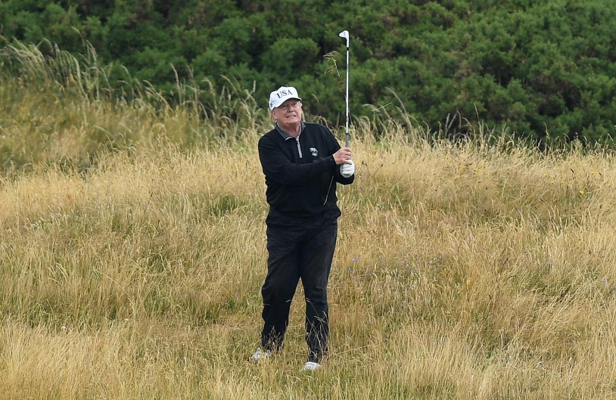 <span class="caption">President Donald Trump plays a round of golf on July 15, 2018 in Turnberry, Scotland. </span> <span class="attribution"><a class="link " href="https://www.gettyimages.com/detail/news-photo/president-donald-trump-plays-a-round-of-golf-at-trump-news-photo/999293088?adppopup=true" rel="nofollow noopener" target="_blank" data-ylk="slk:Leon Neal/Getty Images;elm:context_link;itc:0;sec:content-canvas">Leon Neal/Getty Images</a></span>