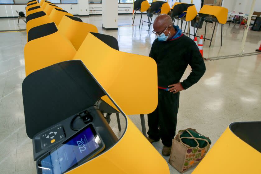 Norwalk, CA - November 03: Michael Jerome Smith works on his ballot at a ballot marking device while voting at Los Angeles County Registrar-Recorder/County Clerk on Thursday, Nov. 3, 2022 in Norwalk, CA. (Irfan Khan / Los Angeles Times)