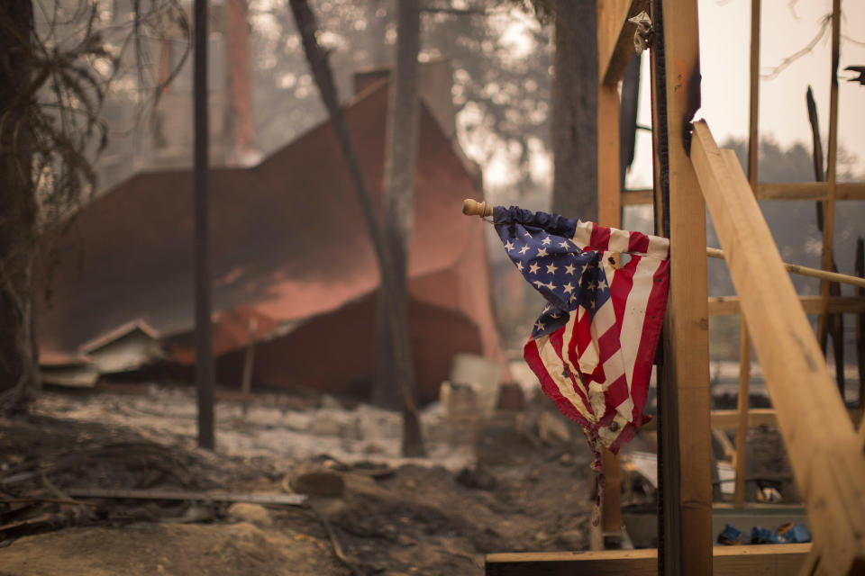 A partially melted American flag hangs in Soda Canyon at a construction site among houses that were destroyed on&nbsp;Oct.&nbsp;11. (Photo: David McNew via Getty Images)