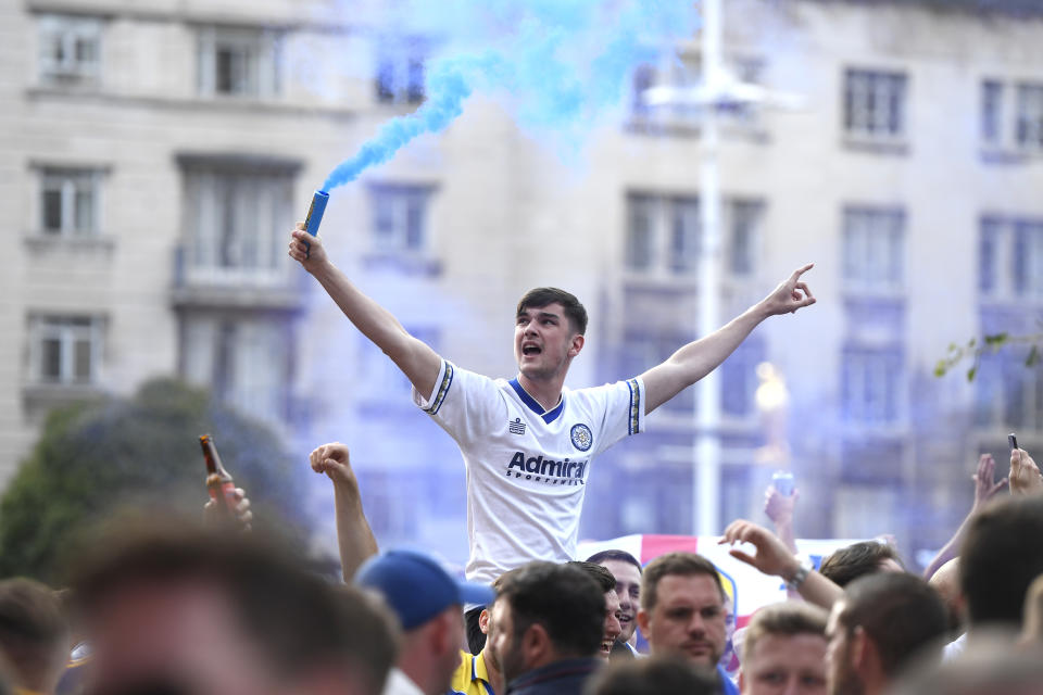 LEEDS, ENGLAND - JULY 19: Leeds United fans celebrate after winning the Sky Bet Championship title at Millennium Square on July 19, 2020 in Leeds, England. (Photo by George Wood/Getty Images)