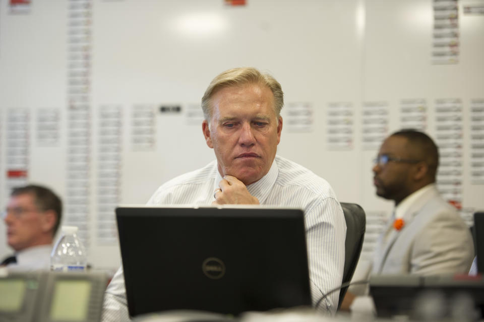 In this photo provided by the Denver Broncos, Denver Broncos vice president John Elway monitors the NFL draft at the NFL football team's headquarters in Englewood, Colo., on Thursday, May 8, 2014. The Broncos are scheduled to pick 31st in the first round.(AP Photo/Denver Broncos, Eric Lars Bakke)