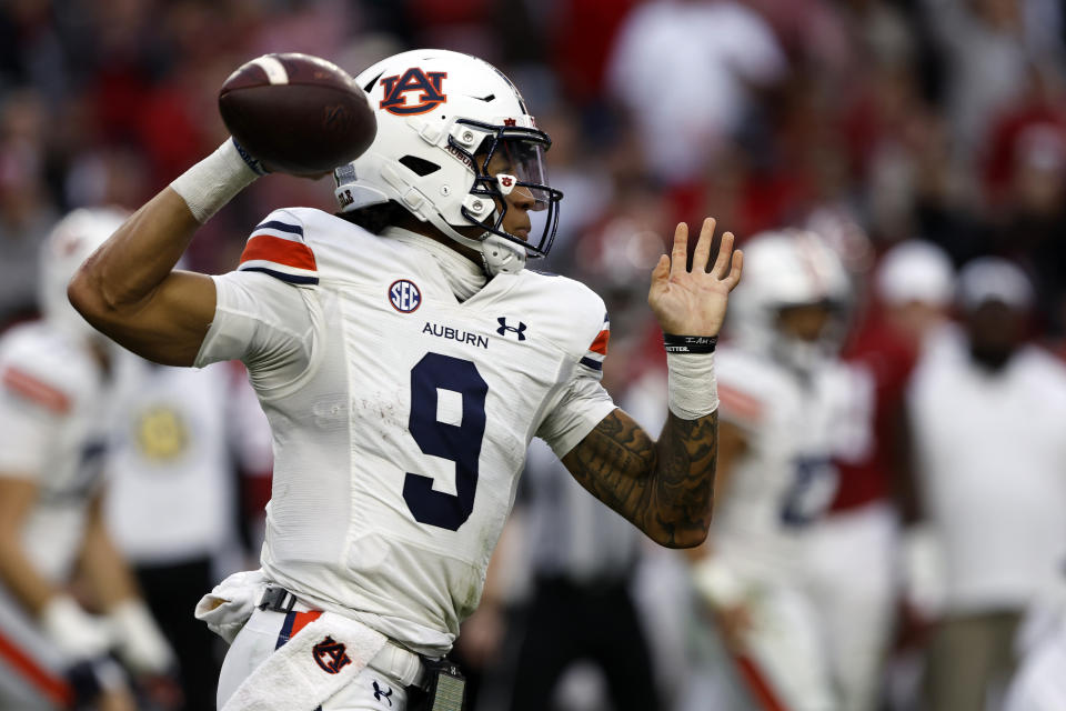 Auburn quarterback Robby Ashford looks to throw a pass against Alabama during the first half of an NCAA college football game Saturday, Nov. 26, 2022, in Tuscaloosa, Ala. (AP Photo/Butch Dill)