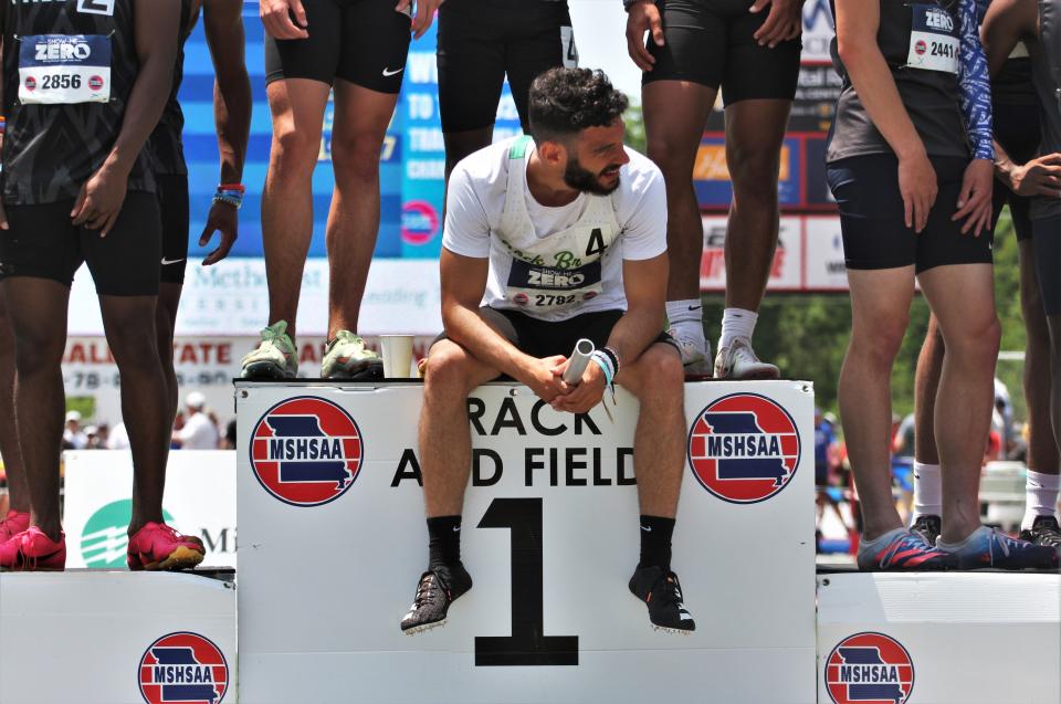 Rock Bridge's Casey Hood sits on at the winner's podium after winning the 4x200-meter relay race during the second day of the MSHSAA state track and field championship meet on May 27, 2023, in Jefferson City, Mo.