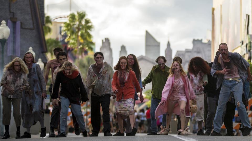 This September 2013 image provided by Universal Orlando in Orlando, Fla., shows actors portraying zombies for the theme park’s Halloween Horror Nights, which take place on select nights through Nov. 2. The zombies are inspired by AMC’s show “The Walking Dead.” One of the park’s eight haunted houses is also themed on the show. (AP Photo/Universal Orlando)