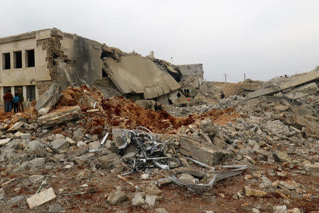 Civil defense members and people inspect a damaged mosque after an airstrike on the rebel-held village of al-Jina, Aleppo province in northwest Syria March 17, 2017. REUTERS/Ammar Abdullah