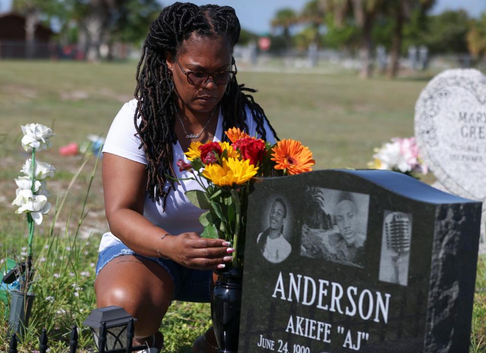 Clover Anderson, of Fort Pierce, places fresh flowers at the gravesite of her son, Akiefe Jamal Anderson, on Saturday, Aug. 12, 2023, at Riverview Memorial Park in downtown Fort Pierce. "This is my weekly life," said Anderson. "We keep him clean because that's the person he was, neat and clean and good." Akiefe, 22, was found with a gunshot wound about 2:45 a.m. on Aug. 28, 2021 on Avenue M Extension east of U.S. 1 north in Fort Pierce. St. Lucie County Sheriff's Office has not announced any arrests but said they are trying to find a 2012 silver Ford Focus in connection with the homicide.