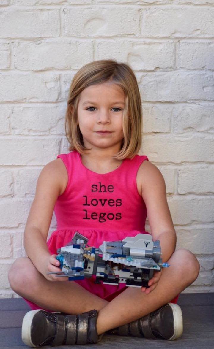 "Our 5-year-old is a strong, smart, and confident girl! She loves Legos, Star Wars, bike riding and skateboarding, but still also enjoys playing dolls, dress-up, and the color pink! She adores building, creating, and using her wild imagination when playing with Legos. She takes pride in completing sets 'all by herself' in addition to coming up with new, creative ideas." (Dress by <a href="https://www.etsy.com/shop/PDPStudio?ref=l2-shopheader-name" target="_blank">PDP Studio on Etsy</a>.)