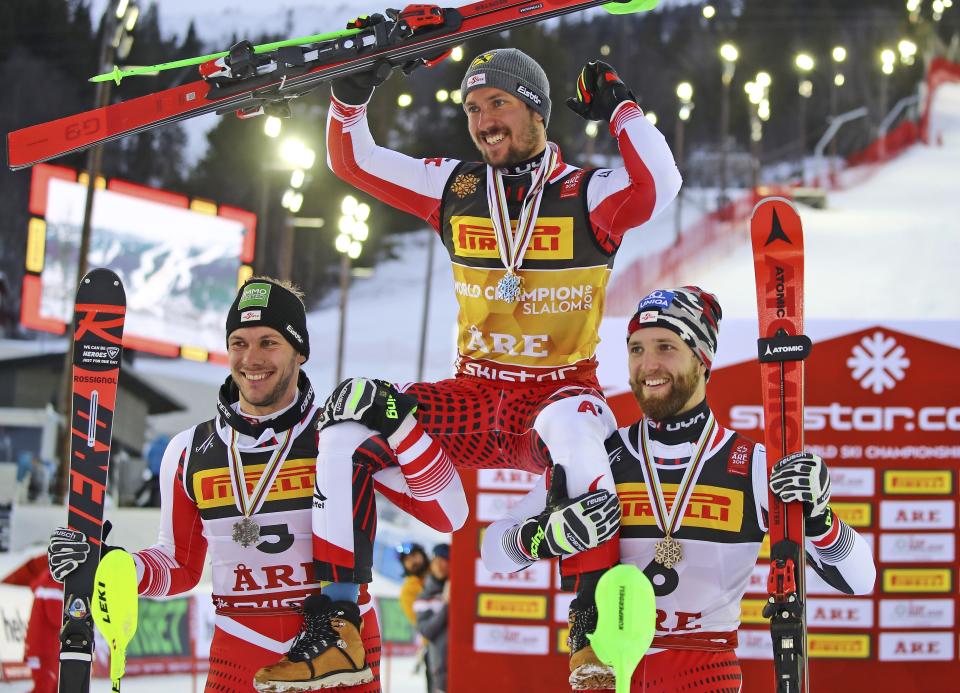 Austria's Marcel Hirscher, center, winner of the men's slalom, celebrates with second-placed compatriot Michael Matt, left, and third-placed compatriot Marco Schwarz, at the alpine ski World Championships in Are, Sweden, Sunday, Feb. 17, 2019. (AP Photo/Marco Trovati)