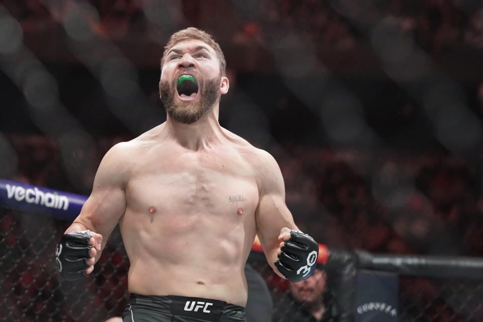 Apr 15, 2023; Kansas City, Missouri, USA; Ion Cutelaba (blue gloves) reacts after the fight against Tanner Boser (red gloves) during UFC Fight Night at T-Mobile Center. Mandatory Credit: Denny Medley-USA TODAY Sports