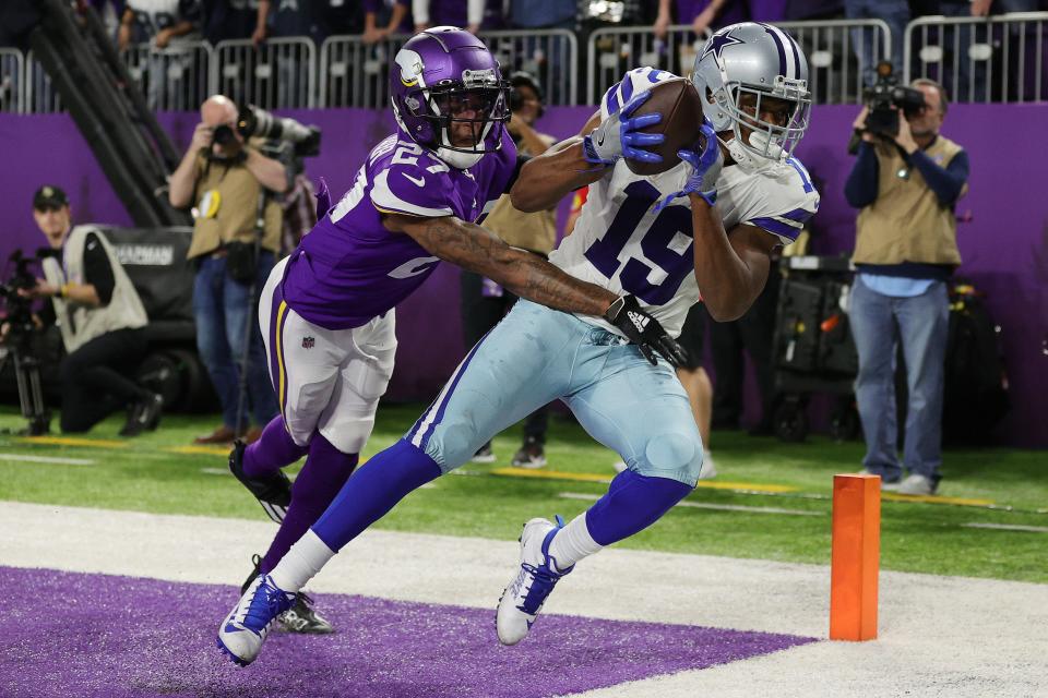 Amari Cooper #19 of the Dallas Cowboys catches a five-yard touchdown pass from Cooper Rush #10 (not pictured) against Cameron Dantzler #27 of the Minnesota Vikings during the fourth quarter at U.S. Bank Stadium on October 31, 2021 in Minneapolis, Minnesota.