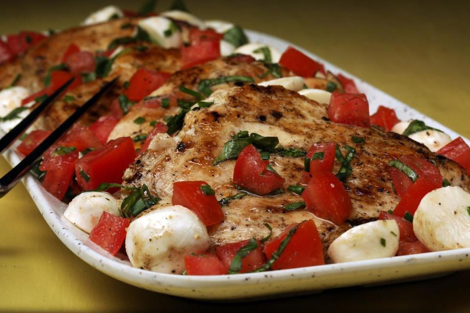 <p>Caprese-style denotes any dish made with mozzarella, basil and tomatoes. It can be served in a variety of ways: as a <a href="https://www.thedailymeal.com/recipes/heirloom-tomato-peach-salad-recipe?referrer=yahoo&category=beauty_food&include_utm=1&utm_medium=referral&utm_source=yahoo&utm_campaign=feed" rel="nofollow noopener" target="_blank" data-ylk="slk:salad;elm:context_link;itc:0;sec:content-canvas" class="link ">salad</a>, <a href="https://www.thedailymeal.com/recipes/copycat-panera-frontega-chicken-panini-recipe?referrer=yahoo&category=beauty_food&include_utm=1&utm_medium=referral&utm_source=yahoo&utm_campaign=feed" rel="nofollow noopener" target="_blank" data-ylk="slk:sandwich;elm:context_link;itc:0;sec:content-canvas" class="link ">sandwich</a>, <a href="https://www.thedailymeal.com/recipes/caprese-skewers-pesto-recipe?referrer=yahoo&category=beauty_food&include_utm=1&utm_medium=referral&utm_source=yahoo&utm_campaign=feed" rel="nofollow noopener" target="_blank" data-ylk="slk:skewers;elm:context_link;itc:0;sec:content-canvas" class="link ">skewers</a> or as an entire entree. This griddle-seared chicken is topped with marinated mozzarella, tomatoes and basil.</p> <p><a href="https://www.thedailymeal.com/best-recipes/griddle-seared-chicken-with-caprese-style-tomatoes?referrer=yahoo&category=beauty_food&include_utm=1&utm_medium=referral&utm_source=yahoo&utm_campaign=feed" rel="nofollow noopener" target="_blank" data-ylk="slk:For the Griddle-Seared Chicken With Caprese-Style Tomatoes recipe, click here.;elm:context_link;itc:0;sec:content-canvas" class="link ">For the Griddle-Seared Chicken With Caprese-Style Tomatoes recipe, click here.</a></p>