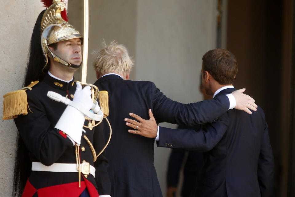 French President Emmanuel Macron, right, and Britain's Prime Minister Boris Johnson enter the Elysee Palace, Thursday, Aug. 22, 2019 in Paris. Boris Johnson traveled to Berlin Wednesday to meet with Chancellor Angela Merkel before heading to Paris to meet with French President Emmanuel Macron. (AP Photo/Michel Spingler)