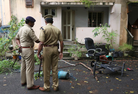 Police officers stand outside the ransacked house of Rehana Fathima, who made an attempt to enter Sabarimala temple which traditionally bars the entry of women of menstrual age, in Kochi, India, October 19, 2018. REUTERS/Sivaram V