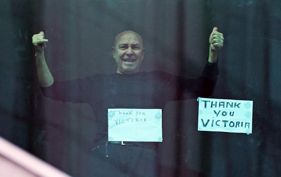 Man gives the thumbs up from the window in his hotel room in Melbourne. Source: AAP 