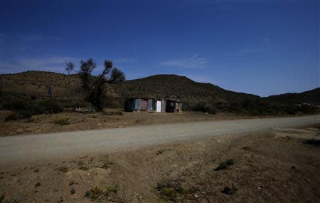 A tin shack sits beside a dusty road near the small town of Nieu-Bethesda in the Karoo October 10, 2013. REUTERS/Mike Hutchings