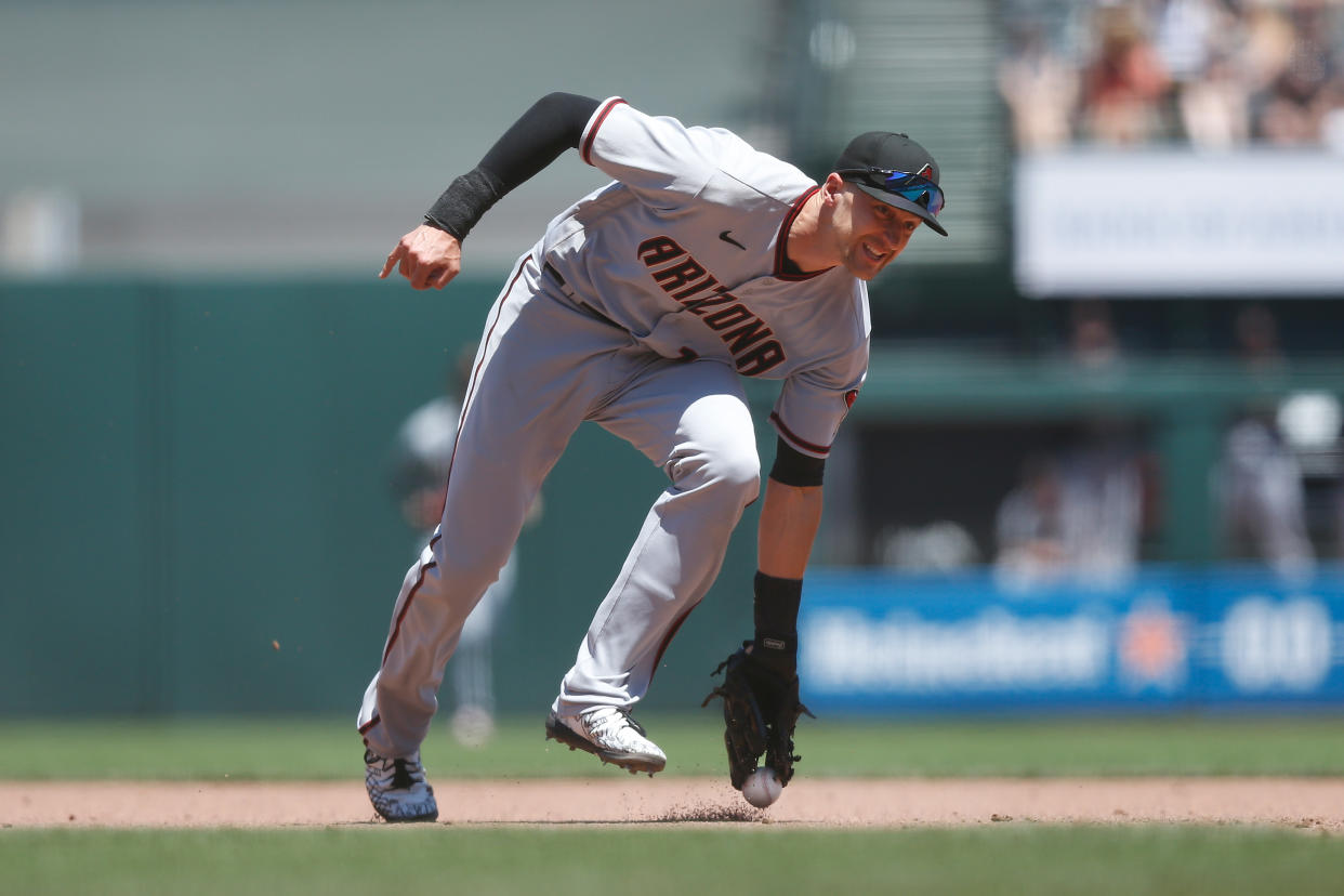 SAN FRANCISCO, CALIFORNIA - JUNE 17: Nick Ahmed #13 of the Arizona Diamondbacks is unable to field the ball in an attempt to flick it to first base for an out in the bottom of the fifth inning against the San Francisco Giants at Oracle Park on June 17, 2021 in San Francisco, California. (Photo by Lachlan Cunningham/Getty Images)