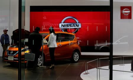 FILE PHOTO: People look at Nissan Motor Co's Note compact car at its showroom in Tokyo, Japan February 9, 2017. REUTERS/Toru Hanai/File Photo