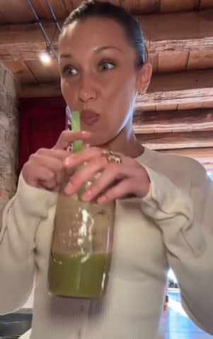 <p>Bella Hadid/Tiktok</p> Bella Hadid drinking green juice