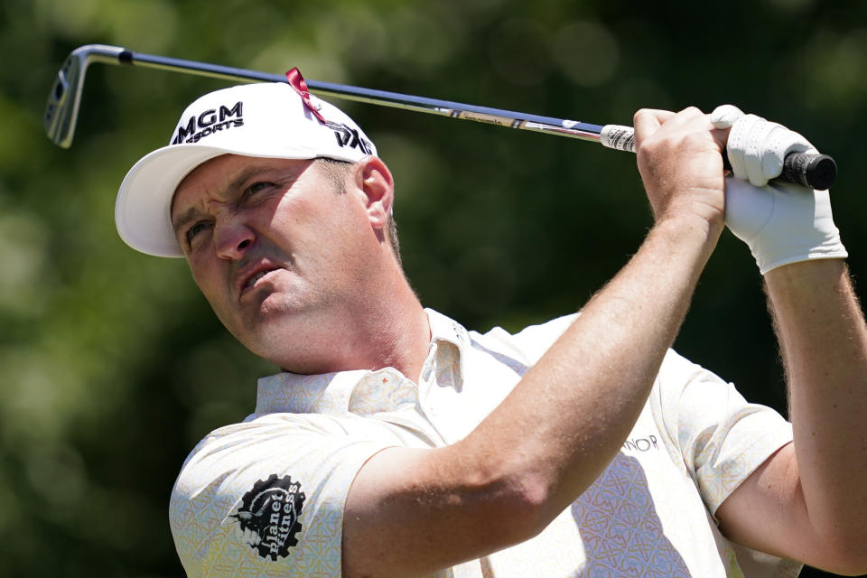 Jason Kokrak hits off the eighth tee during the first round of the Charles Schwab Challenge golf tournament at the Colonial Country Club, Thursday, May 26, 2022, in Fort Worth, Texas. Many players wore ribbons pinned to their caps to show support for the community of Uvalde, Texas _ about 350 miles south of the course _ after 19 students and two teachers were killed in a shooting at an elementary school on Tuesday. (AP Photo/Tony Gutierrez)